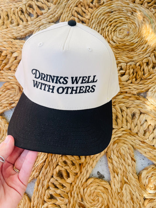 Drinks well with others Trucker Hat